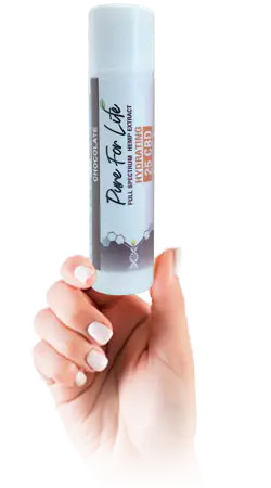 female hand holds the chocolate CBD version of Pure For Life Lip Balm 